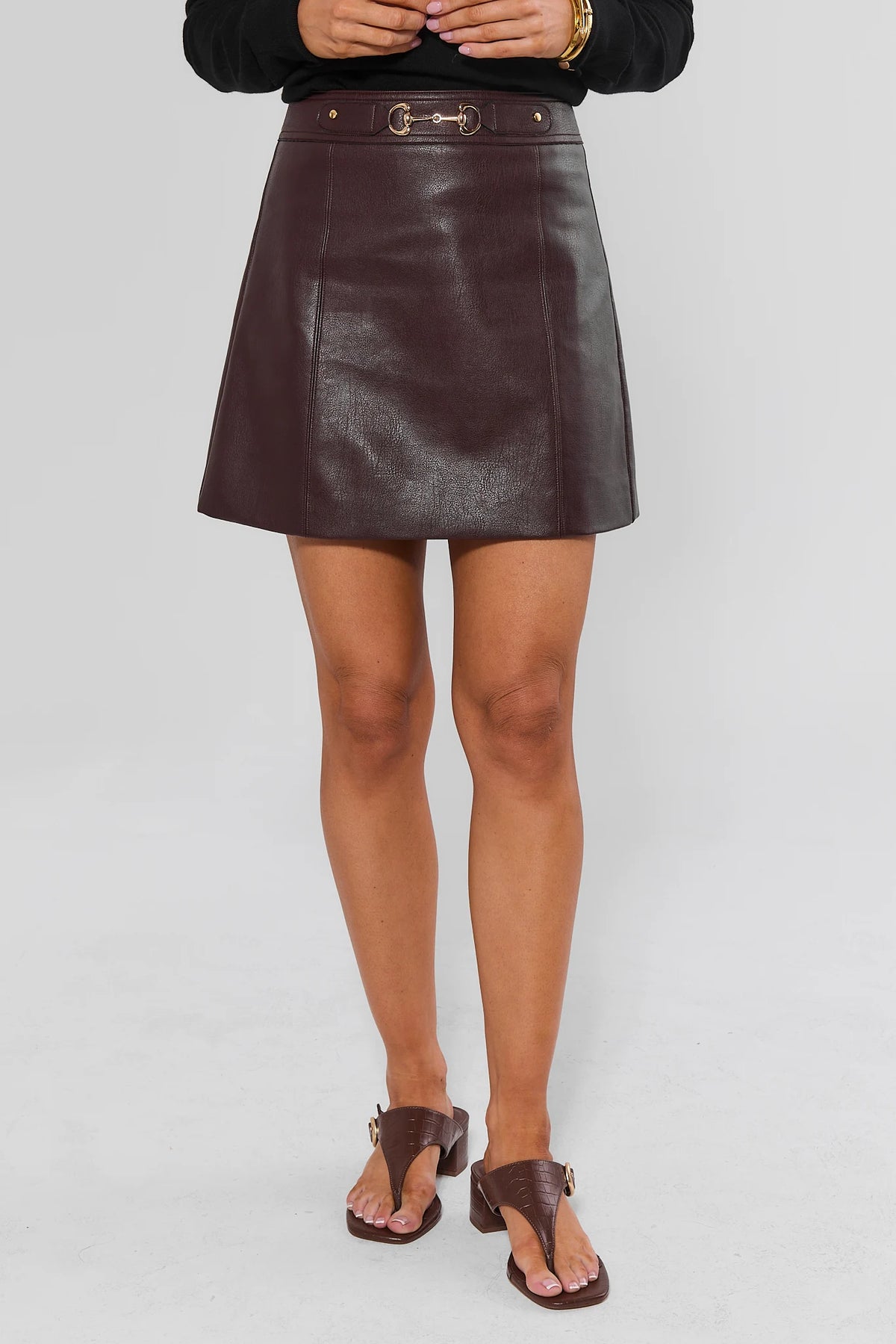 Eleanor Brown Faux Leather Mini Skirt On Model Full Length Front View with Black Sweater | Avara