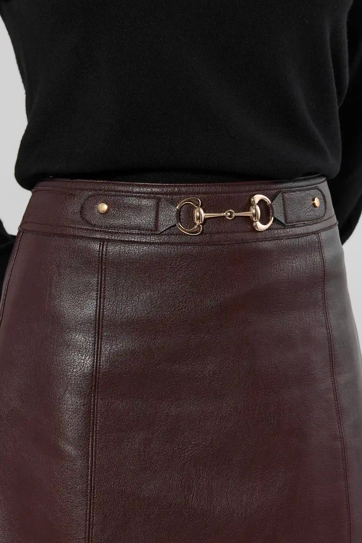 Brown Faux Leather A-Line Mini Skirt Gold Horsebit Waist Hardware Close-Up Detail | Avara