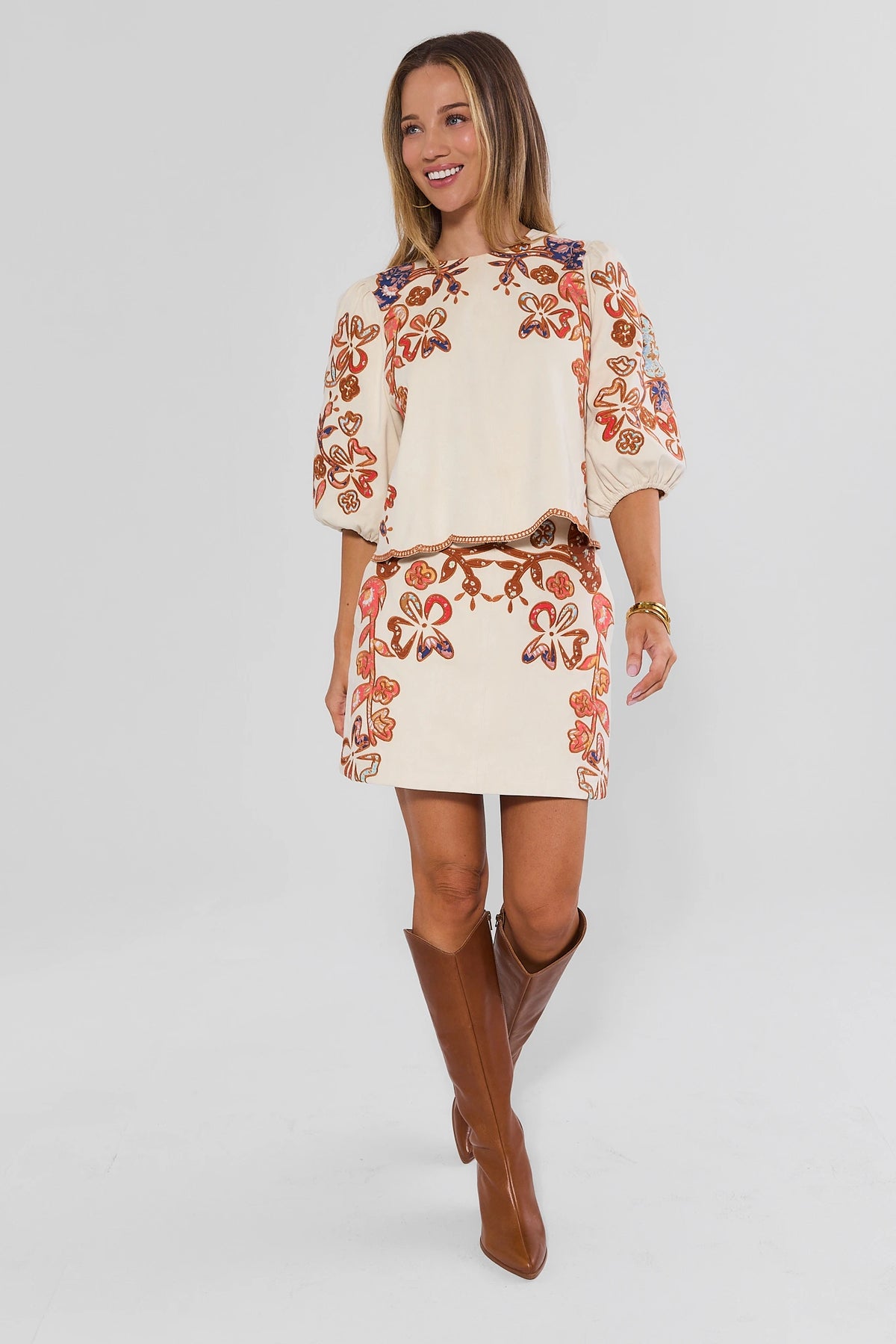 Ivory Faux Suede Mini Skirt with Floral Appliqué - Full Length On Model with Matching Top & Tall Boots | Avara