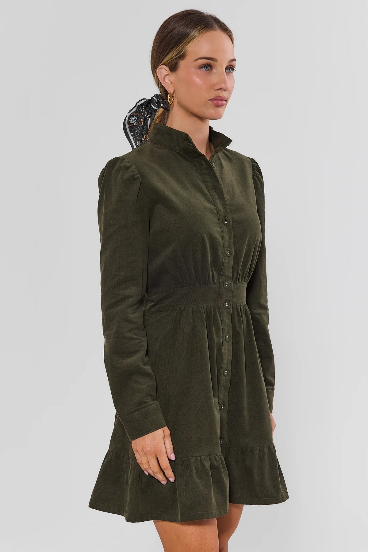 Green Corduroy Short Dress - Side Profile Showing Puff Sleeve, Cinched Waist & Tiered Ruffle Hem | Avara