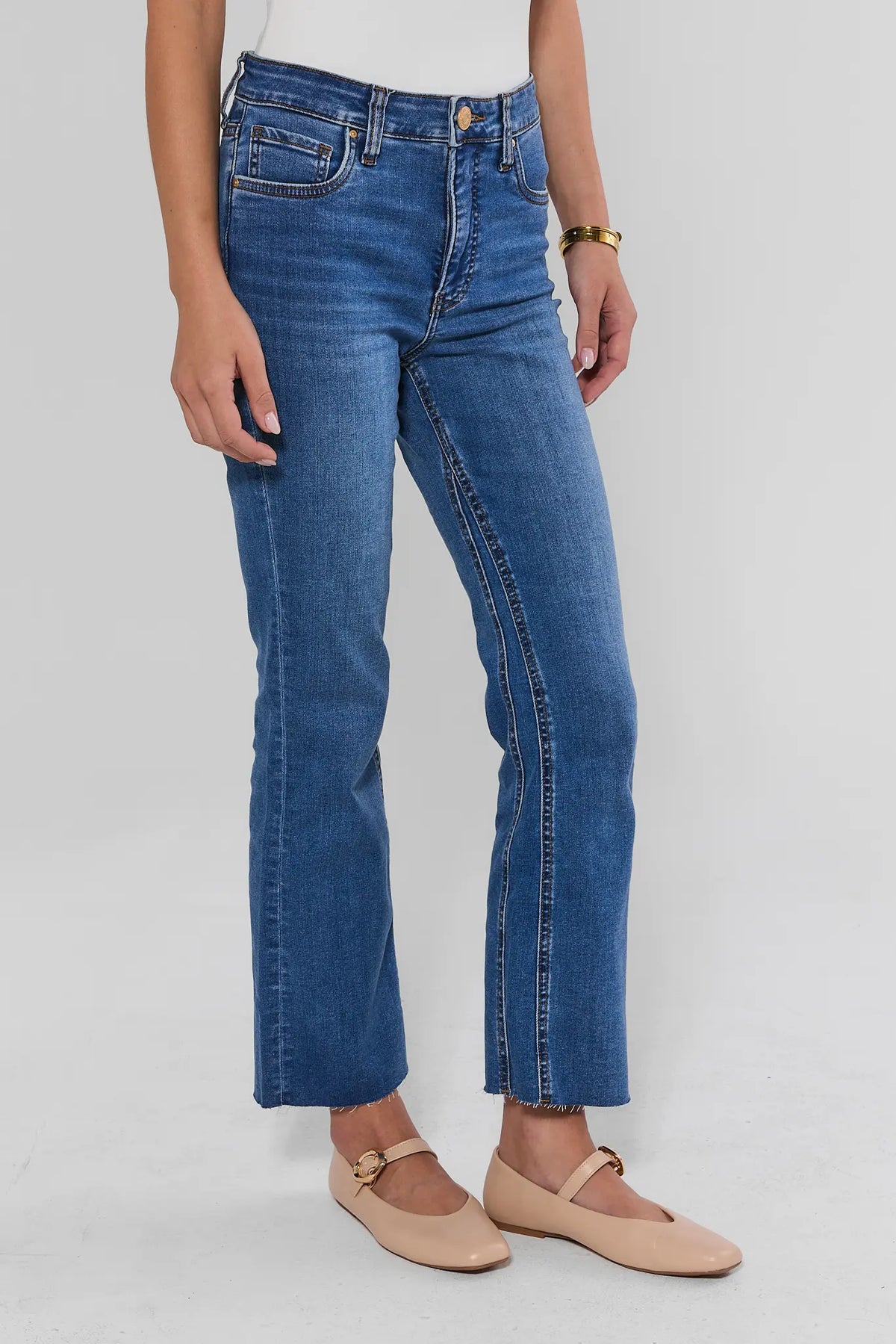 Medium Wash Kick Flare Jeans - Side View Showing Raw Hem and Flare Silhouette | Avara