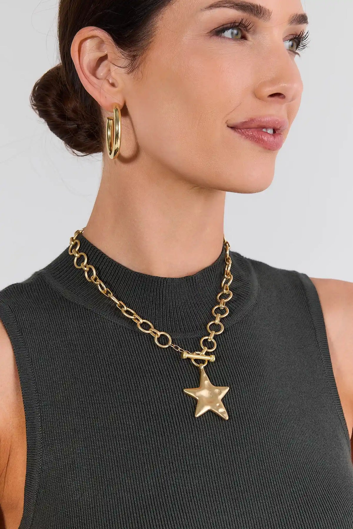 Gold Chunky Star Necklace On Model with Dark Knit Top - Styled Look | Avara