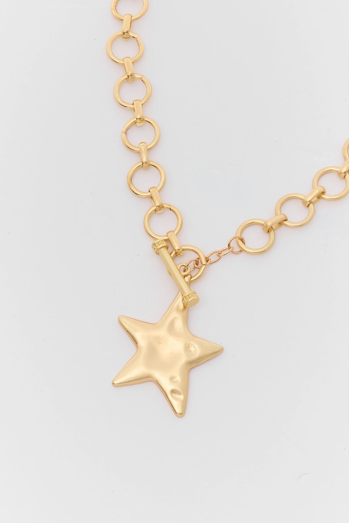 Gold Hammered Star Pendant Close-Up Detail with Toggle Bar Clasp | Avara