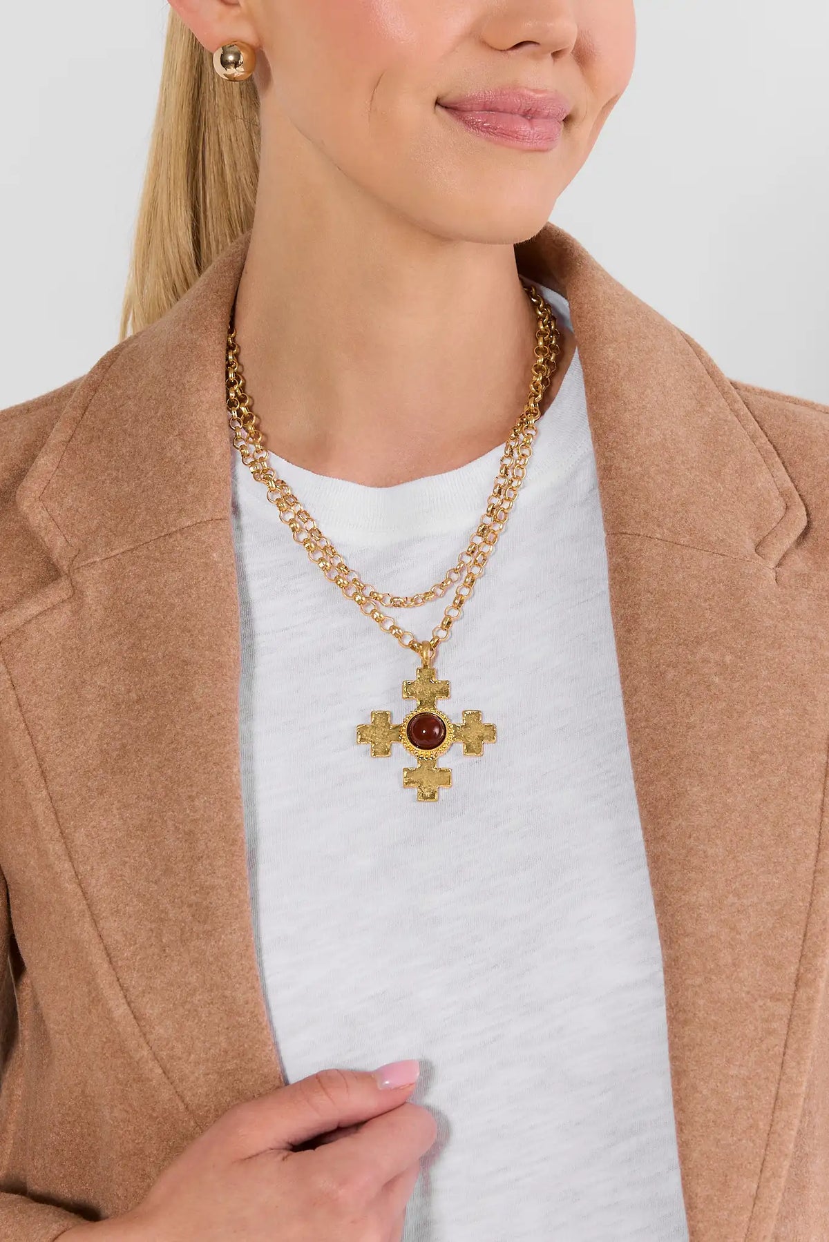 Gold layered cross necklace styled on model with camel blazer - On Model | Avara