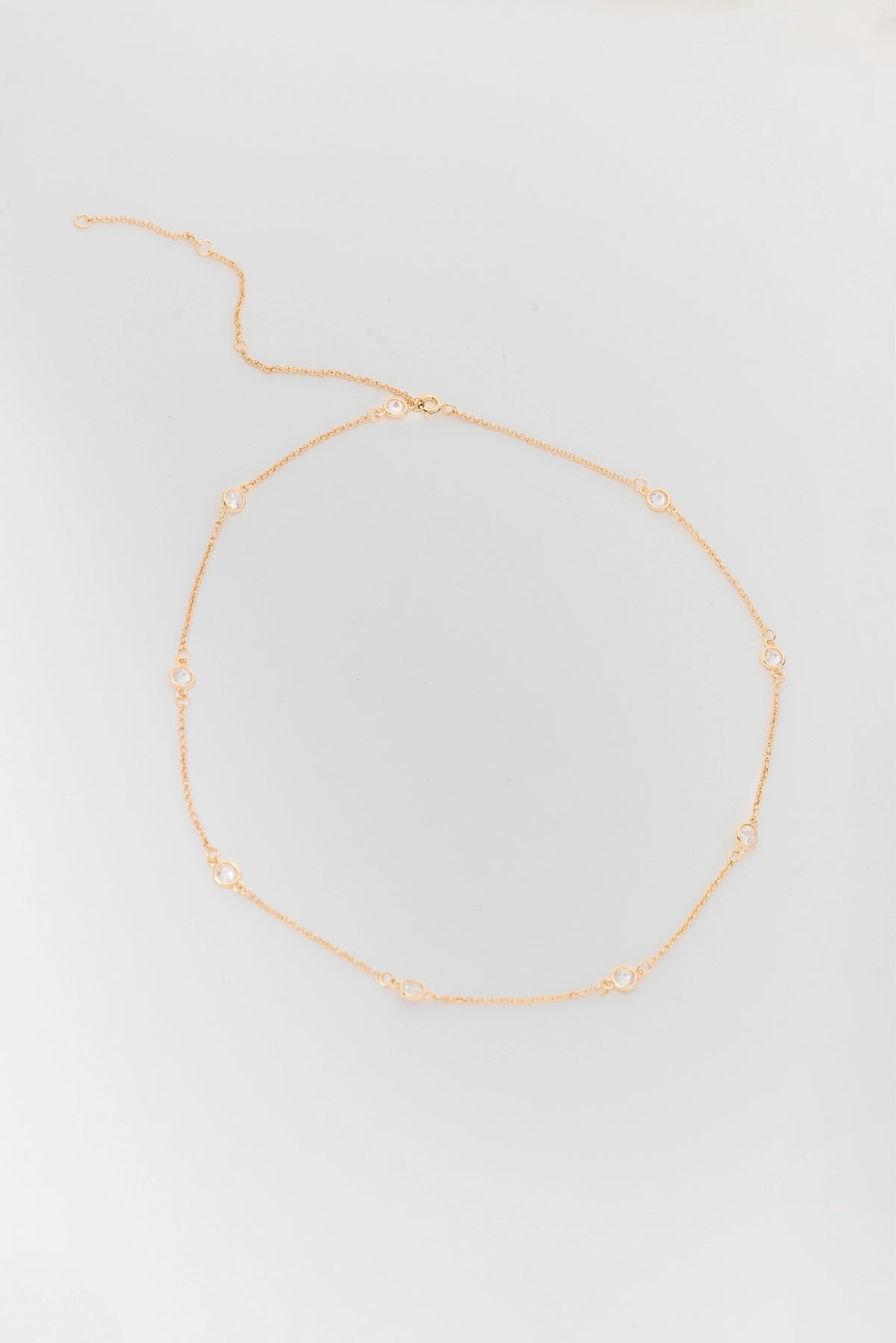 Gold Rhinestone Chain Necklace - Flat Lay with Bezel Stone Detail | Avara