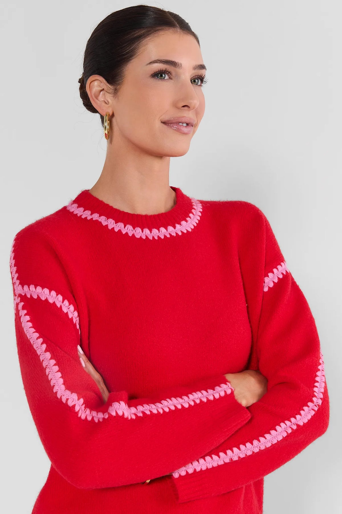 Red Knit Sweater with Pink Trim - Three-Quarter Angle, Arms Crossed | Avara
