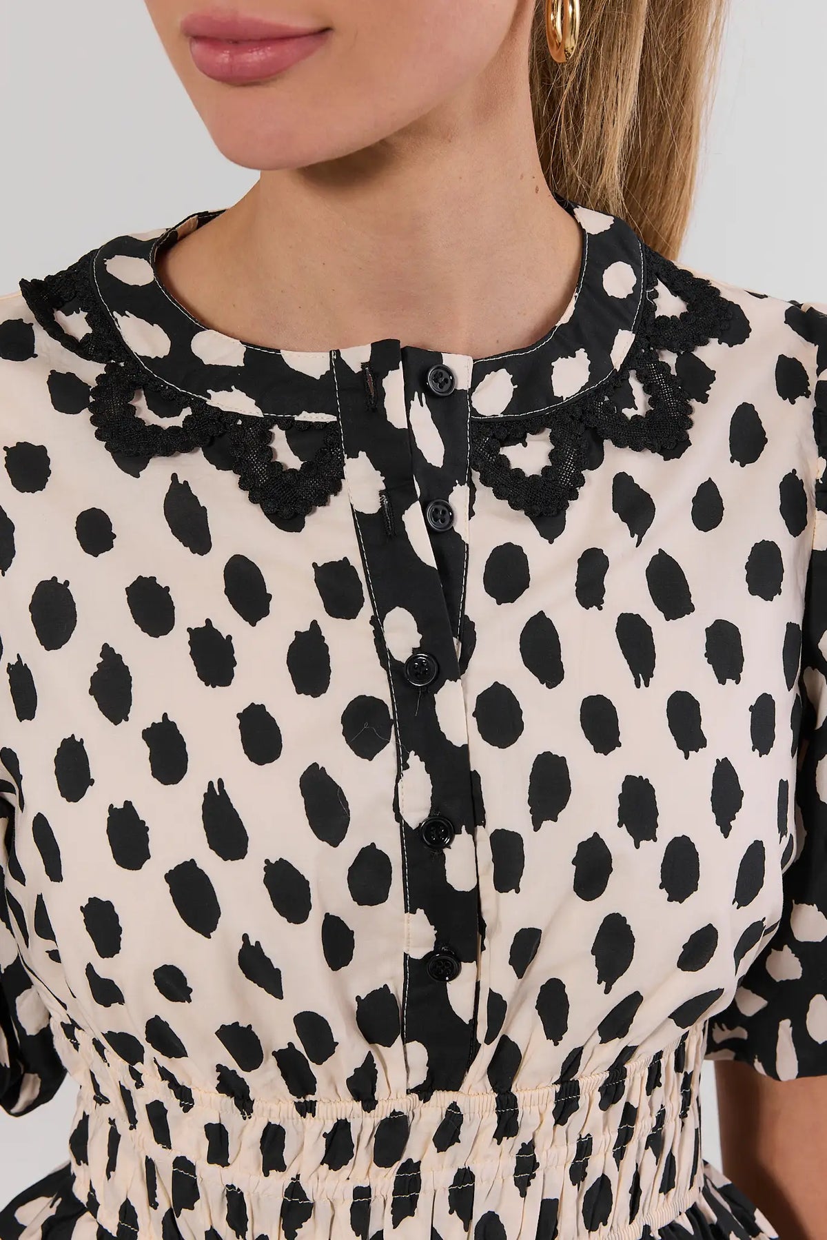 Black Polka Dot Peplum Top - Lace Collar and Button Placket Close-Up | Avara