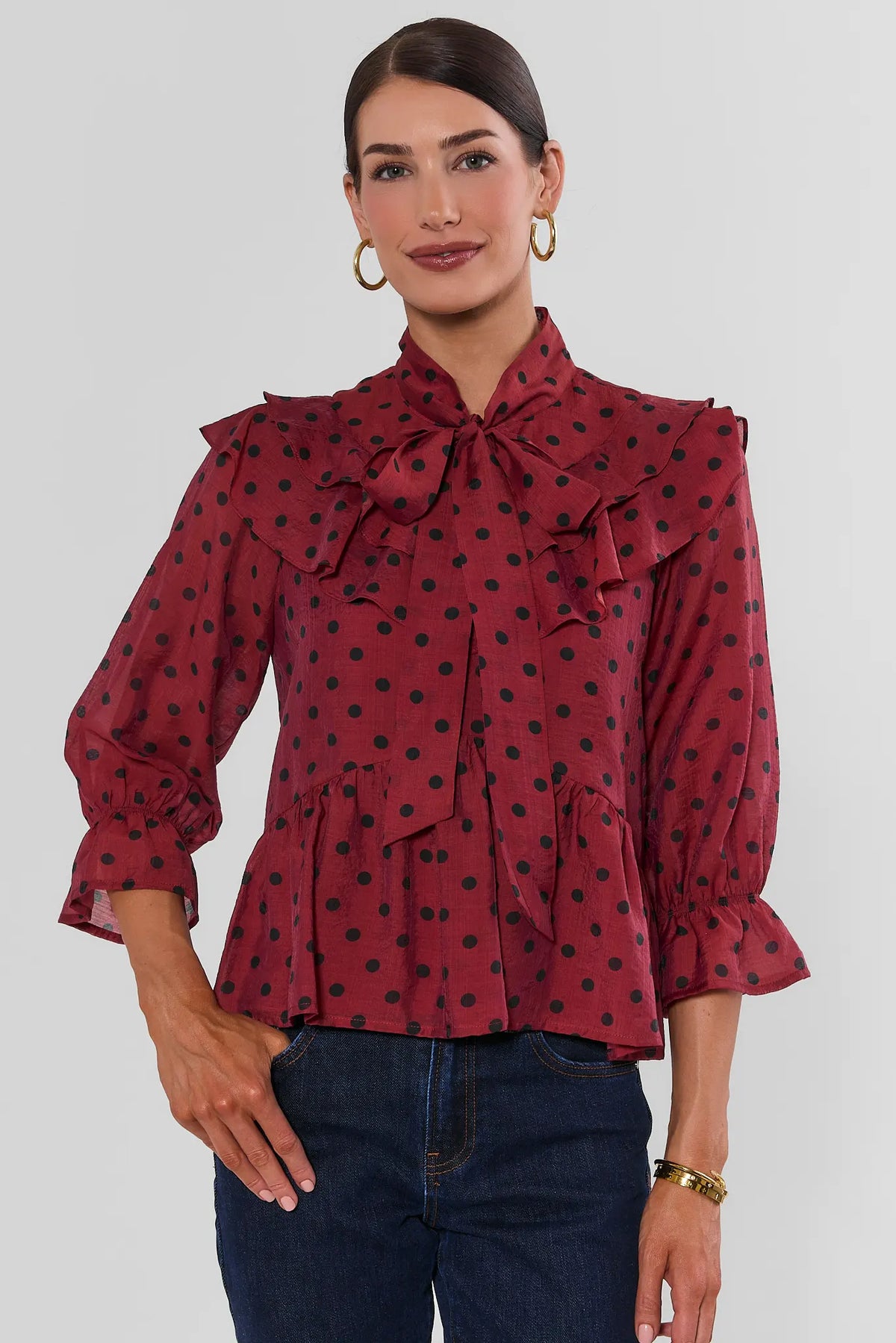 Red Polka Dot Tie Neck Top - Front View On Model with Dark Wash Jeans | Avara