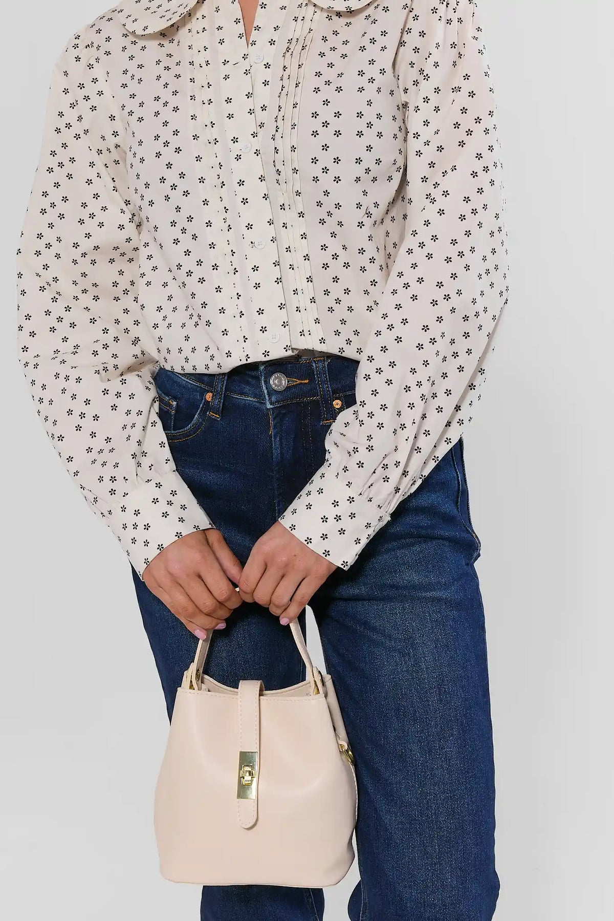 Ivory Faux Leather Bucket Bag Held by Model - Top Handle Close-Up | Avara