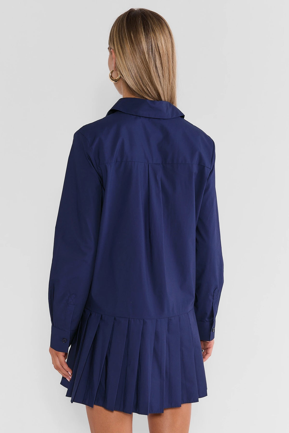 Navy Pleated Skirt Short Dress - Back View On Model, Button Cuffs & Collar Detail | Avara