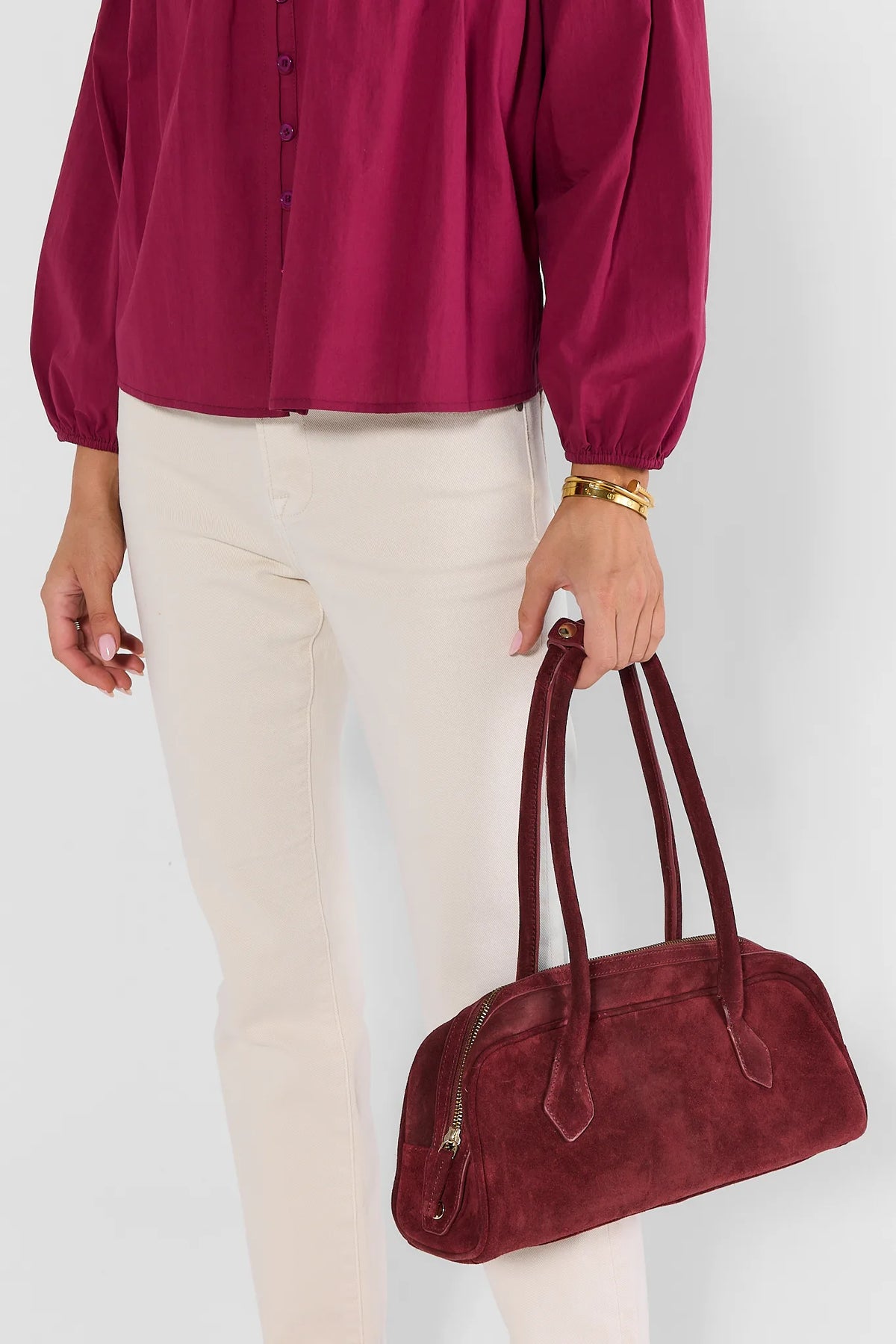 Burgundy Suede Shoulder Bag Held by Model in Magenta Top - Styled Look | Avara