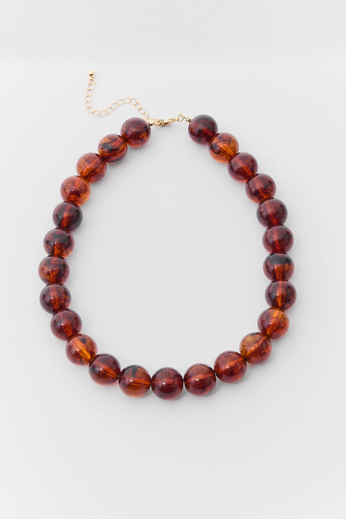 Amber Brown Beaded Statement Necklace - Flat Lay with Gold Clasp | Avara