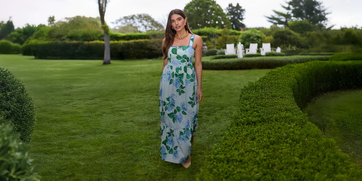 Woman in a floral dress standing in a garden