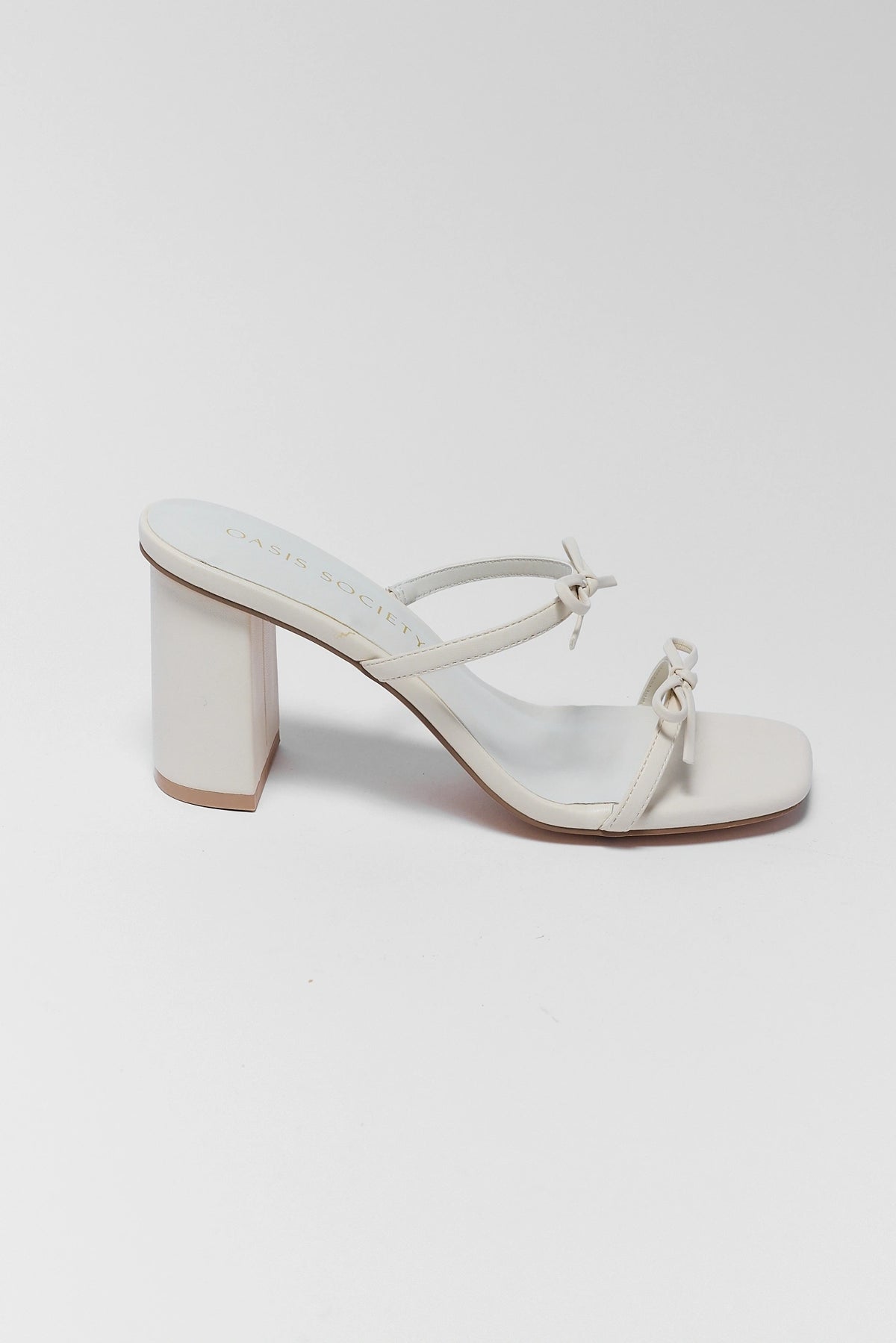 White block heel sandal with double bow straps, side profile view | Avara