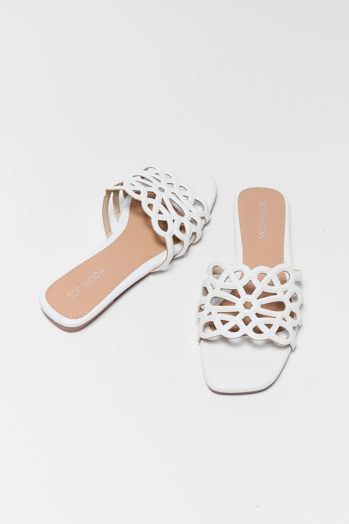 White faux-leather cutout floral sandals, pair overhead flat lay view | Avara