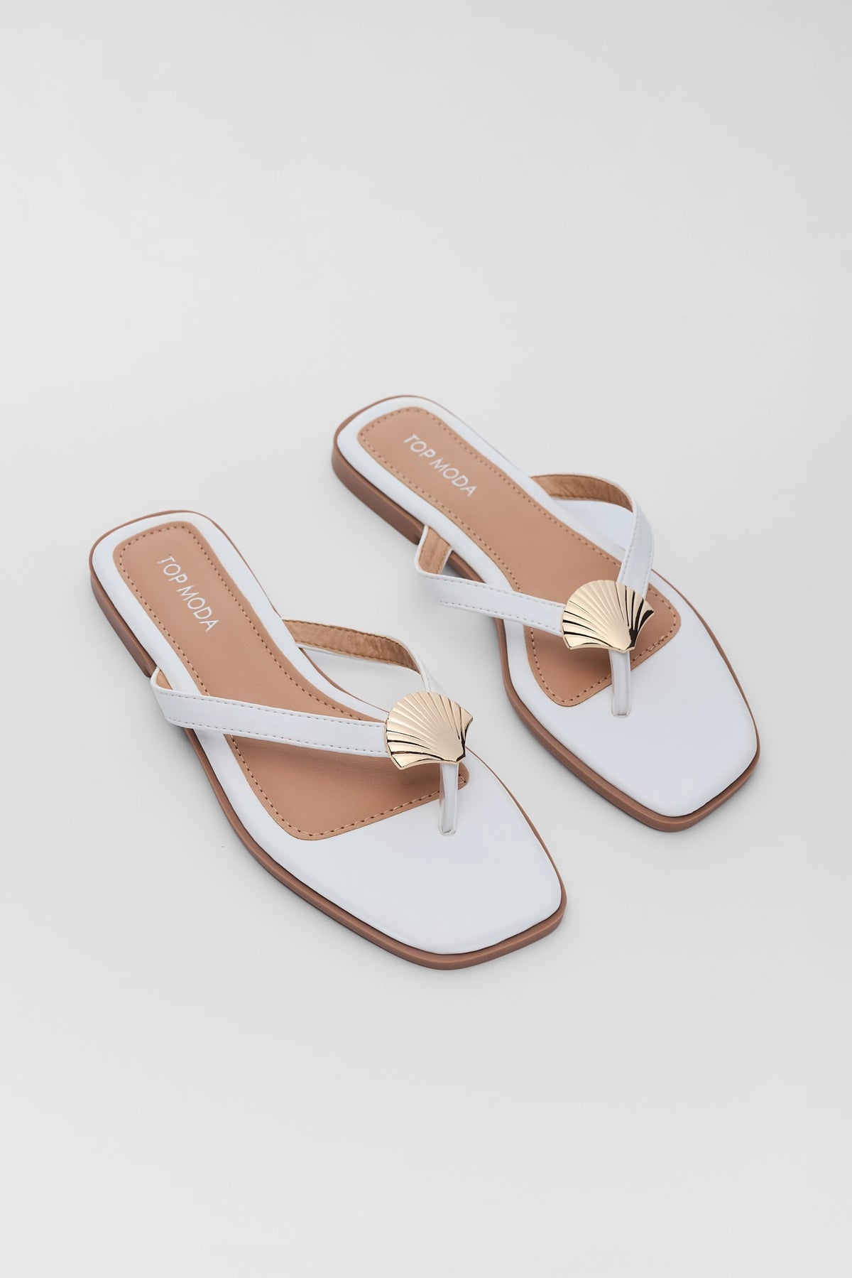 White shell detail sandals with gold seashell accents and square toe - Angled Pair View | Avara