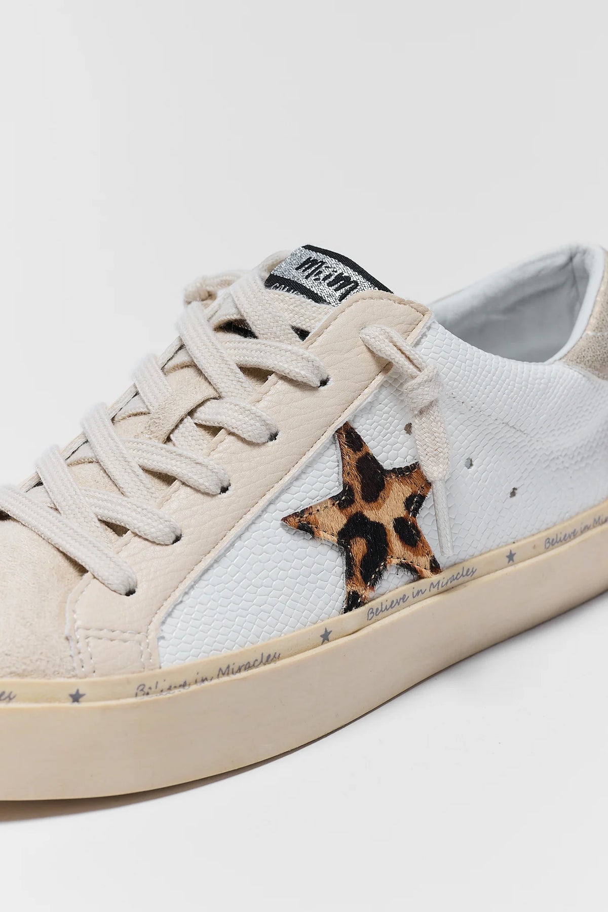 White Leopard Print Star Sneaker - Close-Up Detail, textured upper and haircalf leopard star patch | Avara
