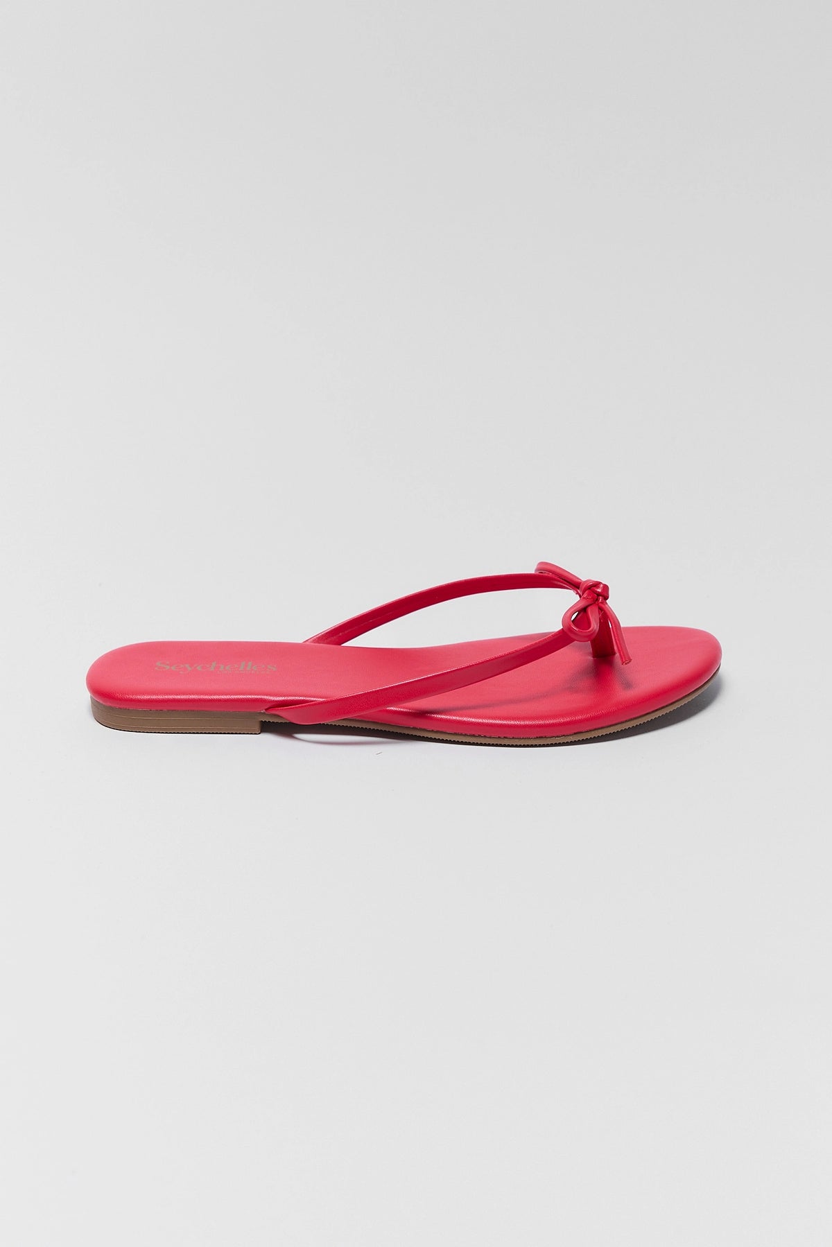 Seychelles red bow sandal - Side Profile View showing slim strap and flat sole | Avara