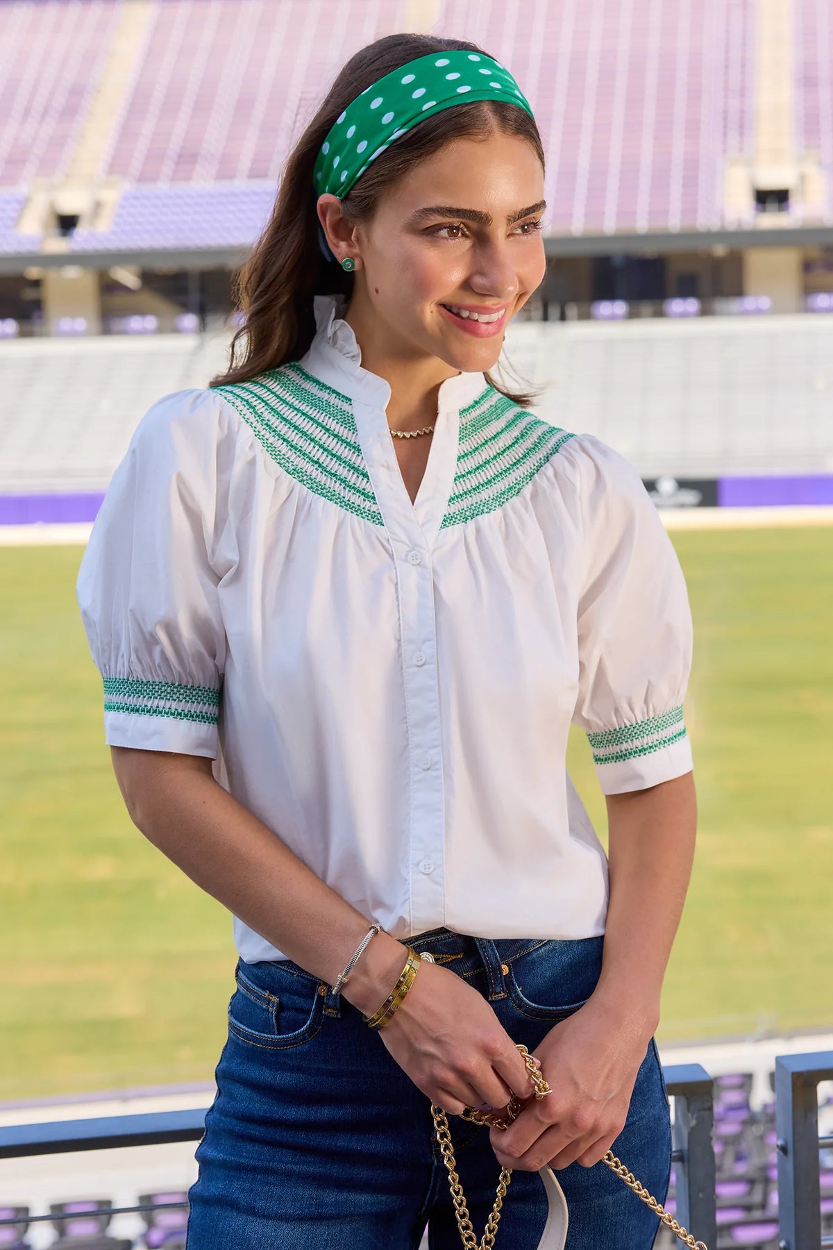 Yvonne White & Green Embroidered Top styled for game day at stadium, paired with jeans | Avara