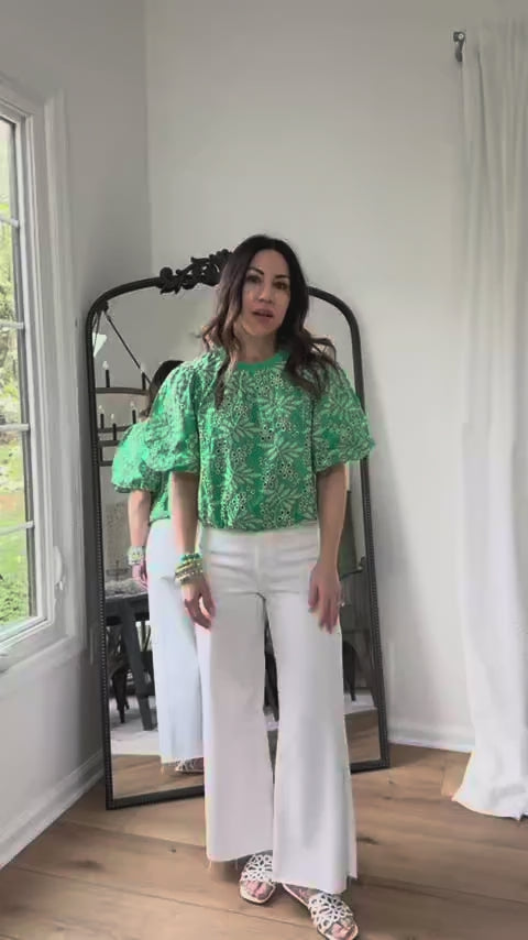 woman wearing green carrigan top with mirror in background