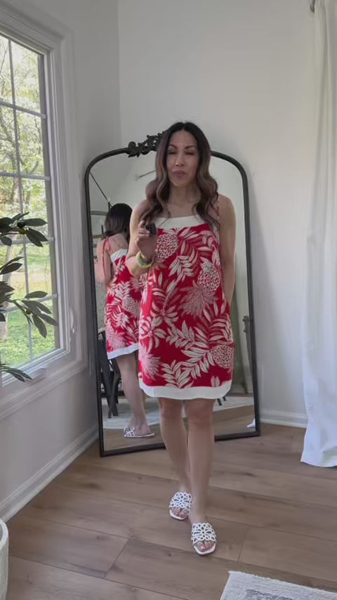 woman wearing red libby dress with mirror in background