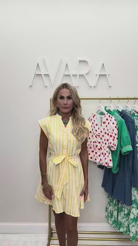 woman wearing yellow erica dress with rack in background