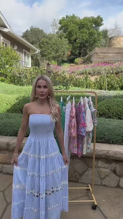 Woman wearing striped strapless midi dress outside 