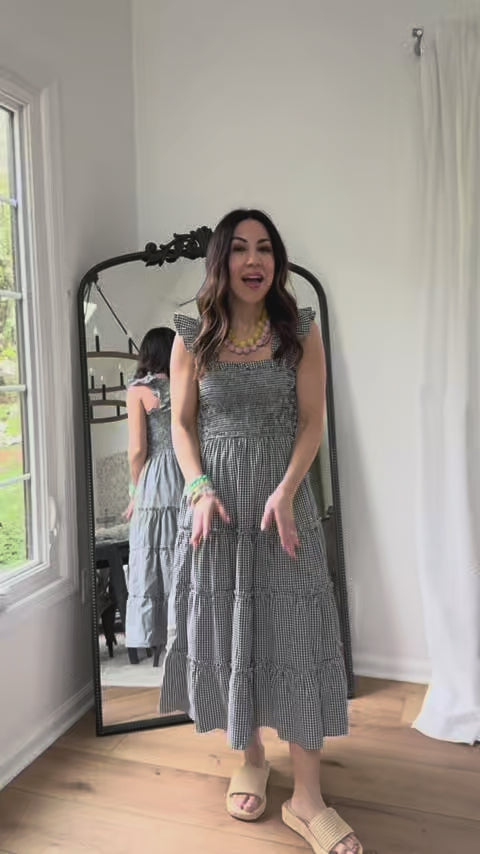 woman wearing black alexandra dress with mirror in background