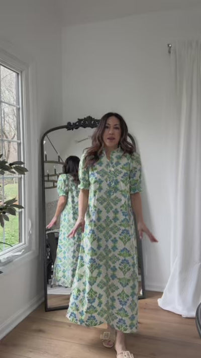 woman wearing midi dress with mirror in background