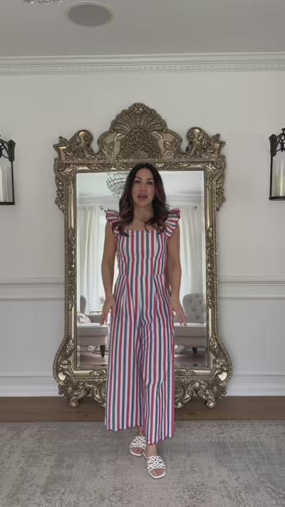 woman wearing multi stripe jumpsuit with mirror in background