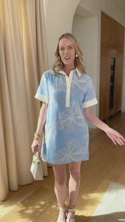 Woman wearing blue angie short dress indoors